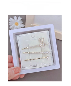 Detailed view of three-piece rabbit ear hair clips with pearls and rhinestones