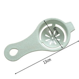 Detail view of a light green egg separator showing 6cm diameter and 13cm length