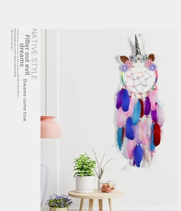 Detail of unicorn dream catcher with colorful feathers and floral silver horn wall decor
