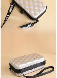Detail of silver hard shell mini crossbody bag with diamond texture and nylon strap