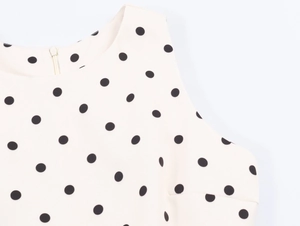 Close-up of the back zipper and polka dot fabric on the sleeveless autumn top