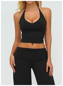 Detail view of black high-stretch v-neck halter sports vest and matching high-waist pants