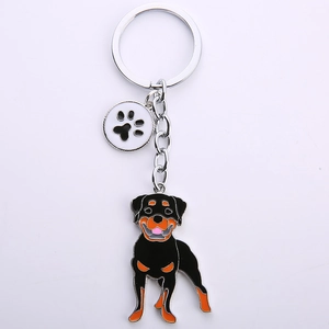 Detail of Rottweiler dog keychain with metallic paw print charm and silver key ring