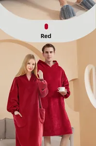 Detail of red oversized hoodie blanket showing thick flannel texture and front pocket
