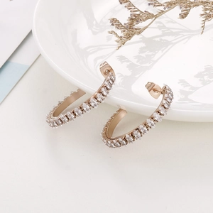 Rose gold hoop earrings with marquise-cut white zircons for a minimalist elegant style