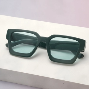 Detail of dark green thick-framed rectangular sunglasses with light blue lenses