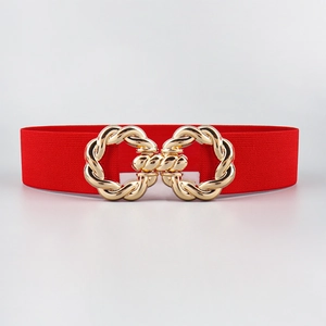 Detail of red elastic waist belt featuring a gold interlocking twisted rope buckle