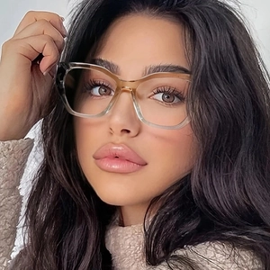 Stylish cat-eye glasses with amber gradient frames worn by model for fashion look