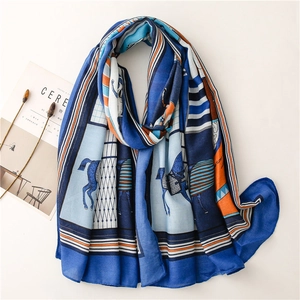 Detail of blue and orange horse pattern scarf with soft cotton-linen texture