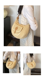 Close-up of woven straw hobo bag showing beige texture and brown leather buckle detail