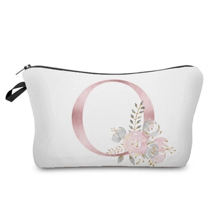 Close-up detail of a white canvas cosmetic bag with a rose gold floral initial O