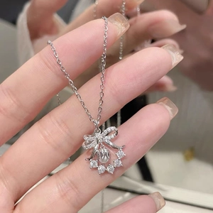 Silver lily of the valley necklace with bow design, zircon stones and pearl pendant