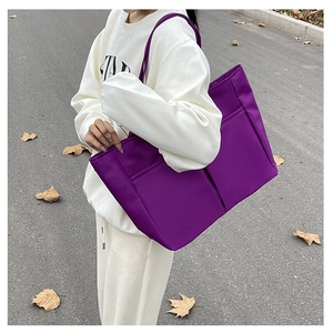 Model wearing purple nylon tote bag over the shoulder for casual style and daily use