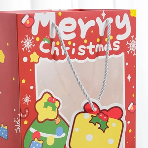 Festive red Christmas gift bag with a clear window and silver braided handle handles