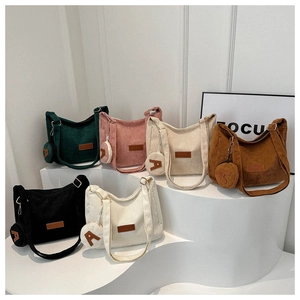 Detail view of colorful corduroy tote bags with matching round letter A coin purses