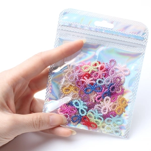 Colorful mix of bow-knot faux pearls for DIY crafts in a holographic pouch