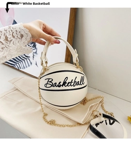 Detail of a white basketball shaped handbag featuring a top handle and woven shoulder strap