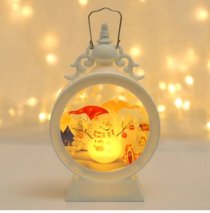 Detail of Christmas snowman lantern ornament with glowing LED light and festive scene