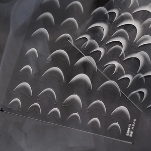 Macro detail of thin flexible French gradient nail stickers for professional DIY manicures