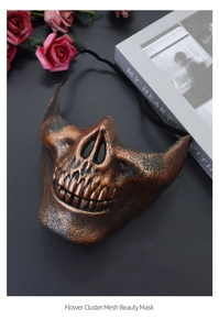 Detail of retro bronze skull mask with black elastic strap on dark gothic background
