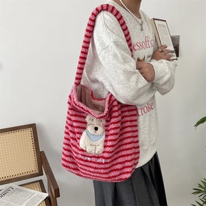 Close-up of pink and red striped plush tote bag with happy dog cartoon embroidery