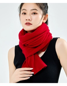 Close-up of a soft red cashmere blend shawl tied neatly, highlighting the knit texture