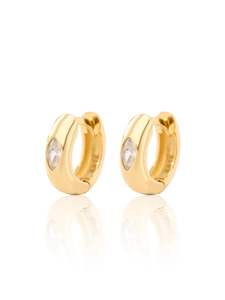 Macro shot of gold hoop earrings with marquise-cut zircon and polished finish