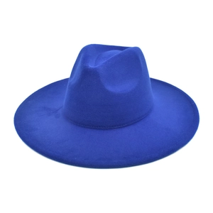Macro view of blue wide brim wool fedora hat with a flat brim and classic indented crown
