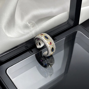 Detail of vintage palace style open ring with lace texture and multicolor gemstones