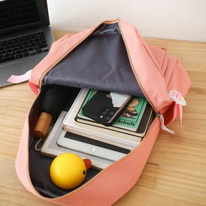 Top view of open pink backpack interior showing ample space for a tablet and books