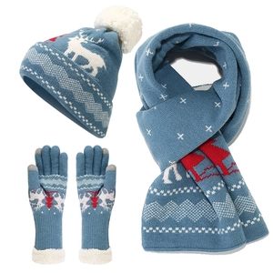 Winter knitted set with blue reindeer and snowflake pattern including hat, scarf, and gloves