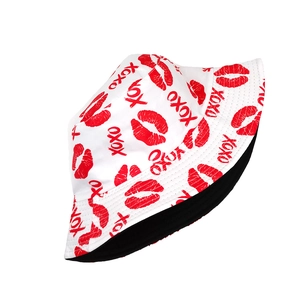 Detail of white bucket hat with red XOXO lips print and black lining for sun protection