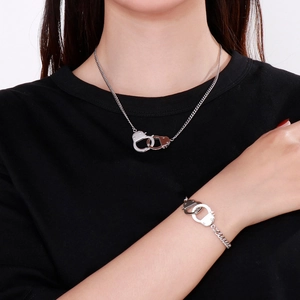 Minimalist silver stainless steel jewelry set with handcuff necklace and bracelet on model