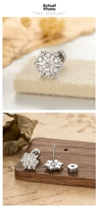 Detailed view of silver snowflake stud earrings with cubic zirconia and screw back