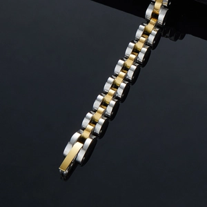 Polished two-tone gold and silver stainless steel link bracelet for women on dark surface