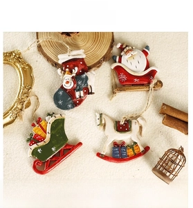 Detail of colorful resin Christmas ornaments with Santa and reindeer on white fabric