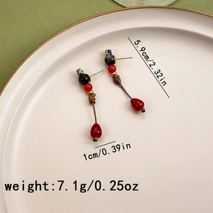 Detail view of red and black beaded earrings with size labels and water drop pendants
