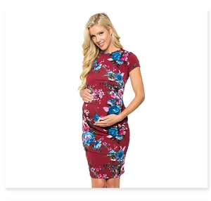 Close-up of floral print and pleated texture on a burgundy maternity short sleeve dress