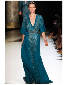 Close-up of peacock green evening dress with intricate sequin lace and floral embroidery