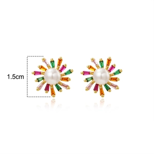 Close-up of 1.5cm sunburst earrings with central pearl and colorful zircon stones