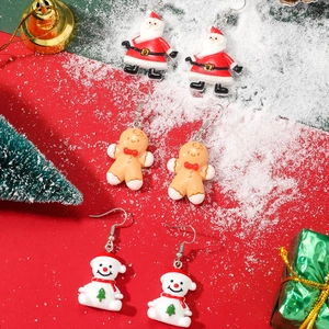 Festive Christmas earrings featuring Santa, Gingerbread Man and Snowman on white snow