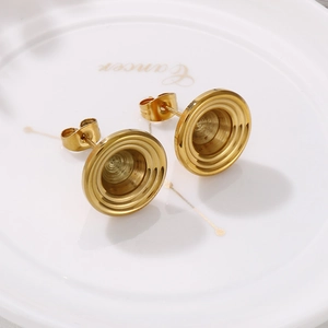 Detailed view of gold stainless steel stud earrings with concentric circle spiral design