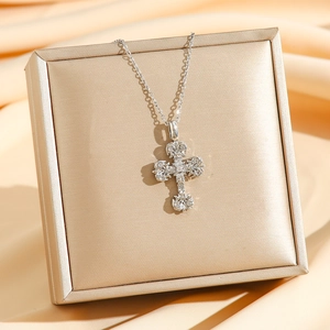 Vintage silver cross pendant necklace with zircon inlays on golden jewelry box