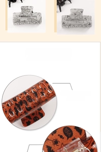 Detailed view of Halloween hair claw clip with spider web patterns and smooth glitter finish