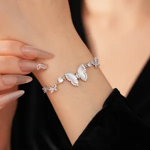 Elegant silver butterfly bracelet with mother-of-pearl wings and zircon stones on wrist
