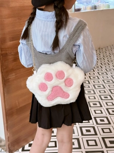 Detail of a white plush cat paw crossbody bag with pink pads and a gold chain strap