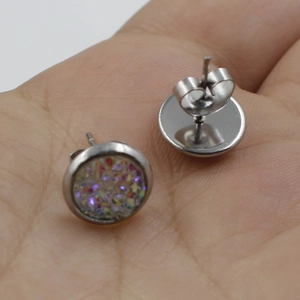 Detailed view of 8mm stainless steel stud earrings with colorful glitter in palm