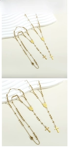 Close-up of golden stainless steel rosary beads with holy medal and cross pendants