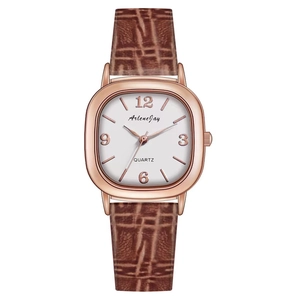 Detail of square rose gold watch with brown crocodile leather strap and white dial