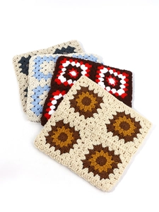 Detail of colorful hand-crocheted grandmother square patterns with intricate textures